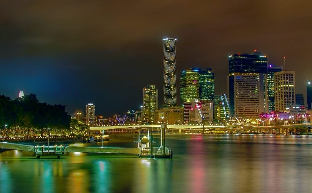 city lights reflecting on body of water