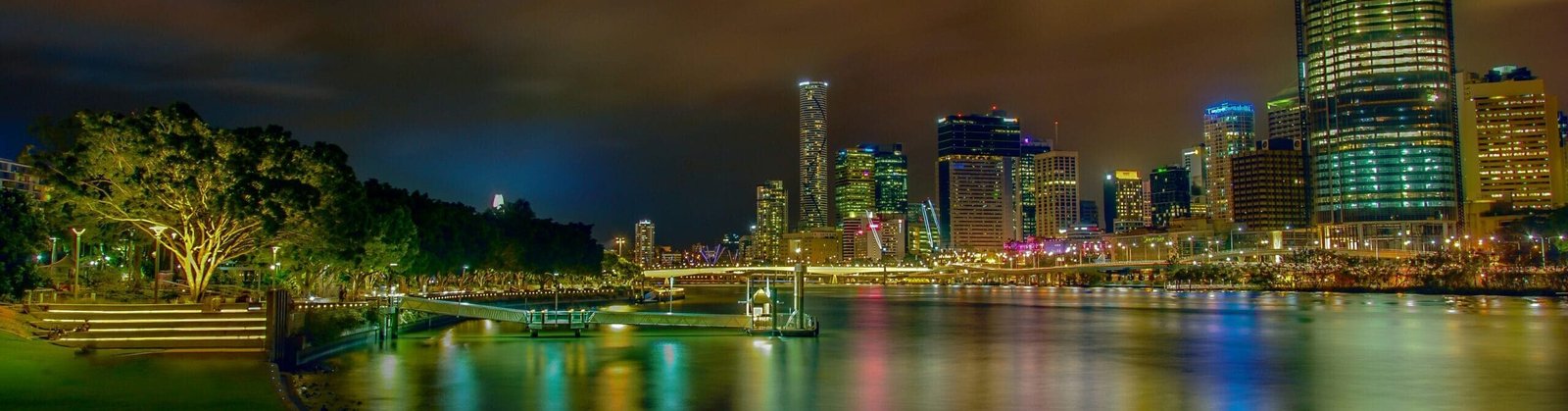 city lights reflecting on body of water